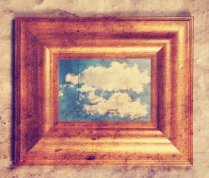 a distressed frame with a cloud in it toned with a retro vintage