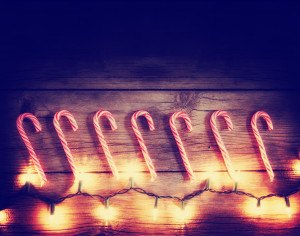 a row of candy canes and christmas lights toned with a retro vin