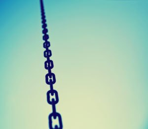 a big metal chain going up to the sky toned with a retro vintage