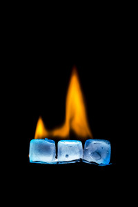 Burning ice cubes on a dark background.