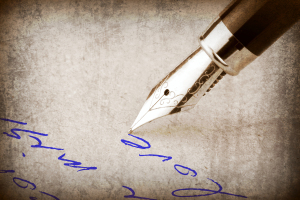 Close-up of a fountain pen gliding in blue ink across textured paper, capturing the essence of CRPS coping techniques.