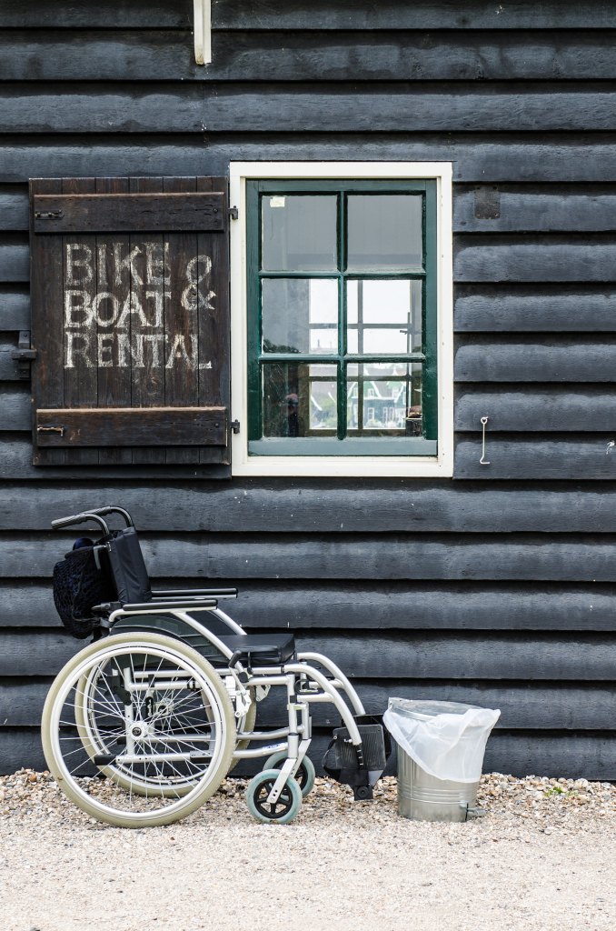 Wheelchair Standing Front Of A House - Bike And Boat Renting