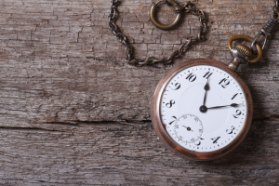 Old Gold Pocket Watch On A Chain On An Old Wooden