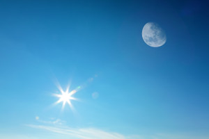 Bright sun and visible moon in a clear blue sky offer a serene backdrop, much like finding reliable self-help resources for chronic illness; they both bring clarity and peace to the mind.