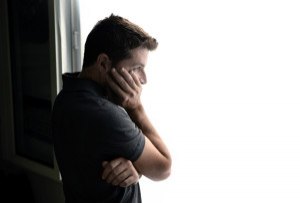 Attractive Man Looking Through Window Suffering Emotional Crisis