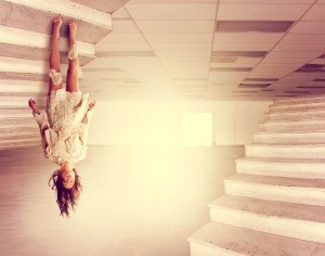 a beautiful woman defying gravity in a large empty warehouse do