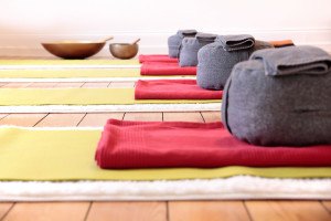 Close-up of yoga mats and yoga cushion in yoga studio
