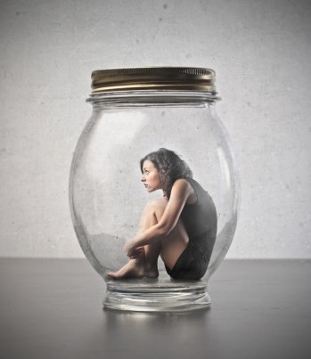 Young woman sitting in a jar