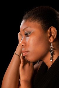 Crying african ghanese young woman shedding tears