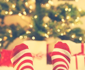 Feet With Striped Socks With Christmas Gift Boxes